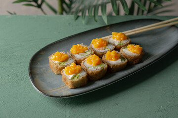 Hot tempura sushi on a gray dish close-up