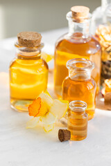 Assortment of organic essential oils. Natural moisturizing body and face treatment. Rose, camomile extract for healthy young skin. Relaxation, aromatherapy, salon spa. Close up, macro view