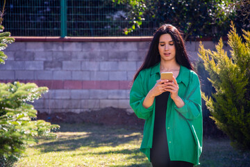 Fototapeta premium Beautiful young woman texting on the phone