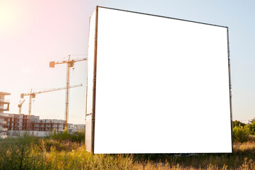 Blank white billboard for advertisement in front of the construction site