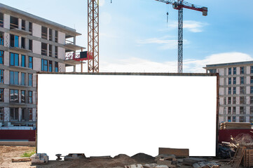 Advertising banner mock-up in front of the residential building under construction. Construction...