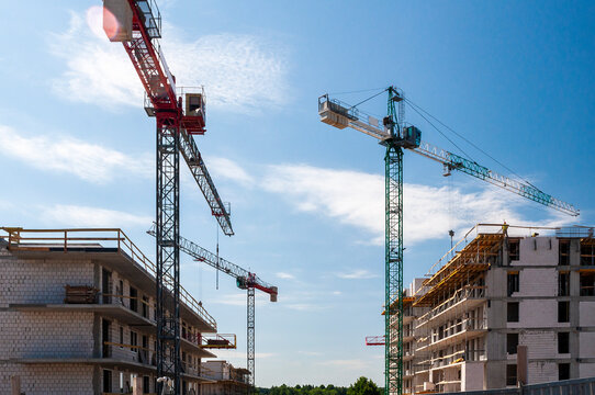 Modern residential buildings under construction. Construction site with tower cranes.