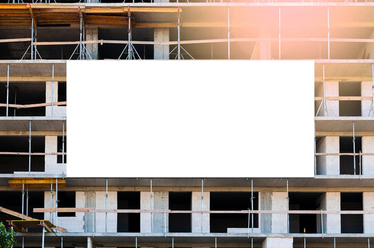 Blank white banner for advertisement on the facade of the building under construction