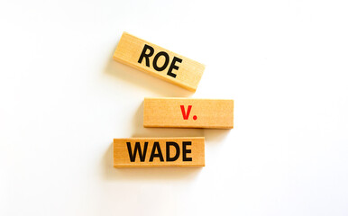 Abortion process Roe versus Wade symbol. Concept words Roe versus Wade on wooden blocks. Beautiful...