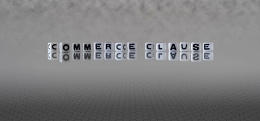 commerce clause word or concept represented by black and white letter cubes on a grey horizon...