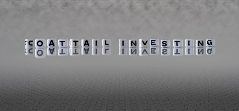 coattail investing word or concept represented by black and white letter cubes on a grey horizon background stretching to infinity
