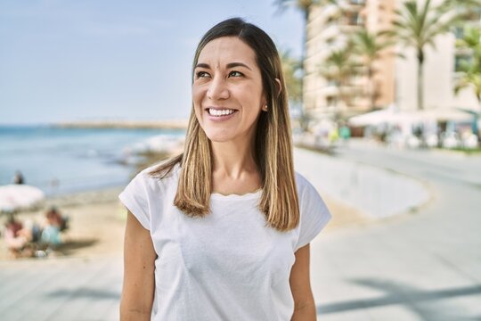 Young hispanic woman smiling confident at seaside