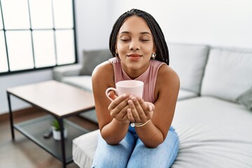 Young african american woman smiling confident drinking coffee at home