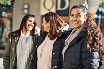 Three woman mother and daughters standing together at street