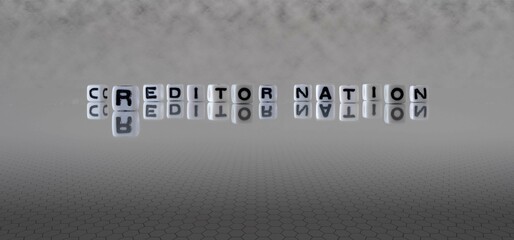 creditor nation word or concept represented by black and white letter cubes on a grey horizon background stretching to infinity