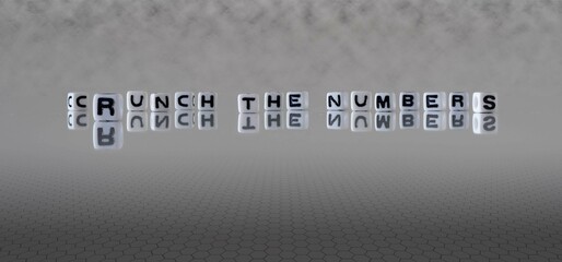 crunch the numbers word or concept represented by black and white letter cubes on a grey horizon background stretching to infinity