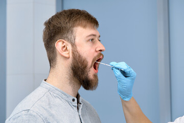 the process of taking a smear from a man's throat
