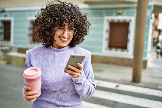 Young middle east woman smiling confident using smartphone at street