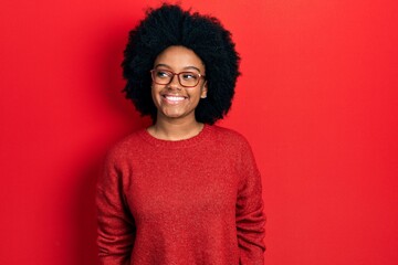 Young african american woman wearing casual clothes and glasses looking to side, relax profile pose...