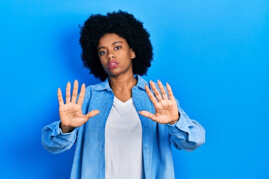Young african american woman wearing casual clothes doing frame using hands palms and fingers, camera perspective