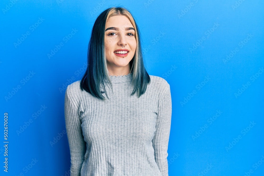 Wall mural Young modern girl wearing casual sweater with a happy and cool smile on face. lucky person.