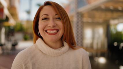 Young redhead woman smiling confident walking at street