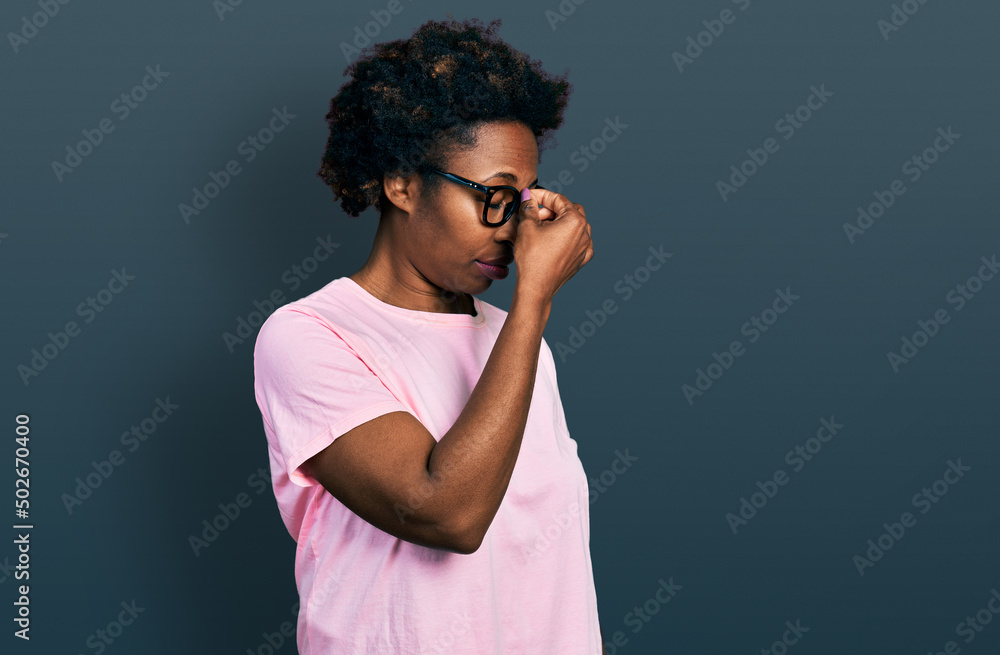 Sticker african american woman with afro hair wearing casual clothes and glasses tired rubbing nose and eyes