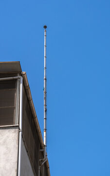lightning rod on pole, blue sky background,