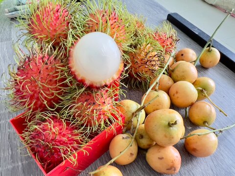 Fresh rambutan sweet tropical fruit and wooden background harvest from the garden, 4 May 2022 , Buriram province.