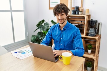 Young hispanic man smiling confident working at office