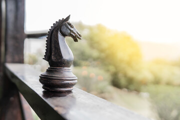 Horse giant chess piece on the wooden balcony of a country house or estate