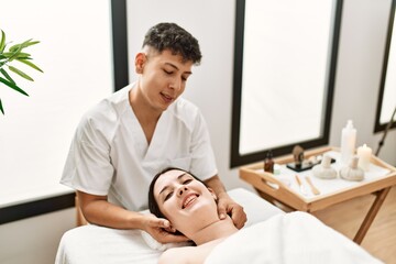 Young woman reciving relaxing massage at beauty center.