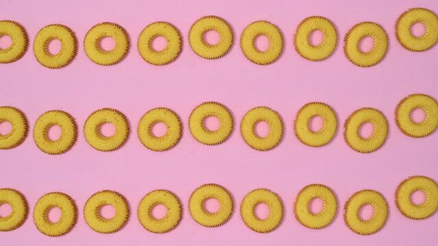 Creative cookies pattern on pastel pink background. Flat lay stop motion