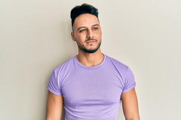 Young arab man wearing casual clothes looking to side, relax profile pose with natural face and confident smile.