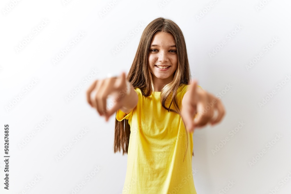 Sticker Young brunette teenager standing together over isolated background pointing to you and the camera with fingers, smiling positive and cheerful