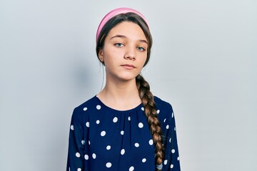 Young brunette girl wearing elegant look relaxed with serious expression on face. simple and natural looking at the camera.