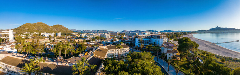 Obraz premium Aerial view of the beach in Palma de Mallorca with the town and harbor below beautiful coastline scenery Spain Mediterranean Sea, Balearic Islands.