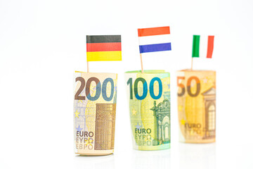 Flags of Germany, France and Italy euro bills on a white background.euro money inflation.Changes in the budget.Inflation and economic recession in Europe. 