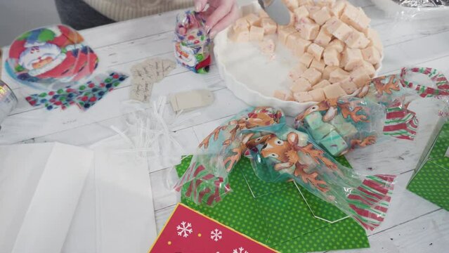 Step by step. Packaging homemade candy cane fudge into small gift bags.