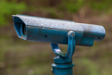 Blue Coin operated binocular with faded glass.