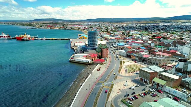 Aerial Forward Shot Of Modern Building In Residential Town By Sea - Punta Arenas, Chile