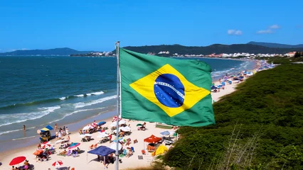 Door stickers Brasil Brazilian flag fluttering in the wind on paradise beach hoisted flag brazil brasil