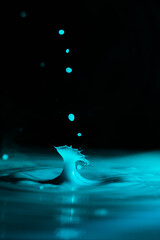 real blue water drop splash in the dark background