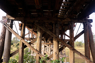 Underside of the old Dickabram wooden bridge with many large trestles crossing Munna Creek at Miva in the South Burnett region of Queensland Australia