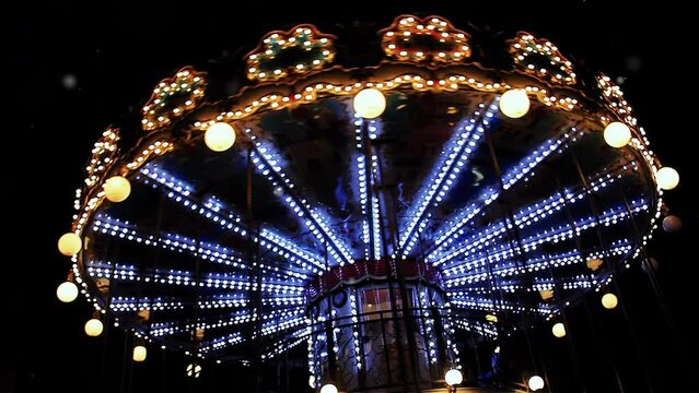 Carousel Below the Eiffel Tower at Twilight, A French Old-fashioned Style Carousel, Carrousel, Merry-go-Round, at Night in Paris, France. Slow Motion. 4K Resolution.