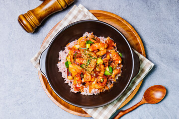 Nakjideopbap, Korean style spicy stir-fried octopus over rice : This dish is made by stir-frying sliced onion and carrots along with sauce over high heat in an oiled pan. Bite-sized pieces of octopus 