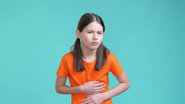 Schoolkid suffer terrible belly abdomen pain isolated cyan color background
