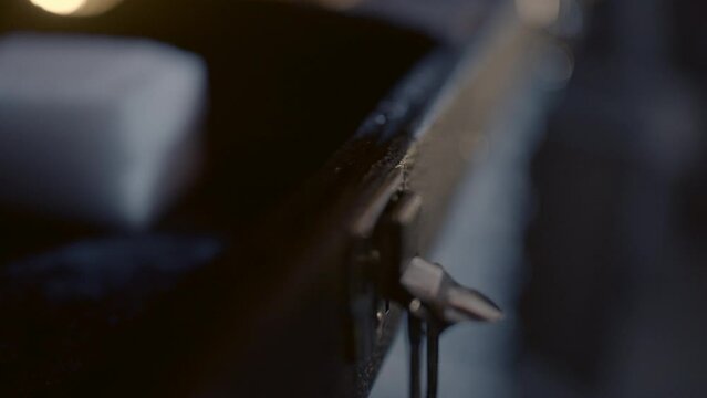 Close-Up Of A Hand Unlatching The Clasp On A Guitar Case And Opening It - Erfurt, Germany