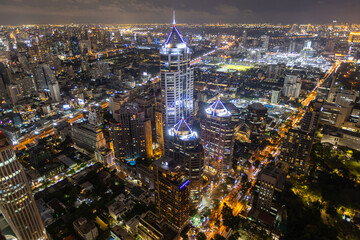 Aerial view of Ploenchit junction with cars traffic skyscraper buildings. Bangkok City in downtown at night, Thailand
