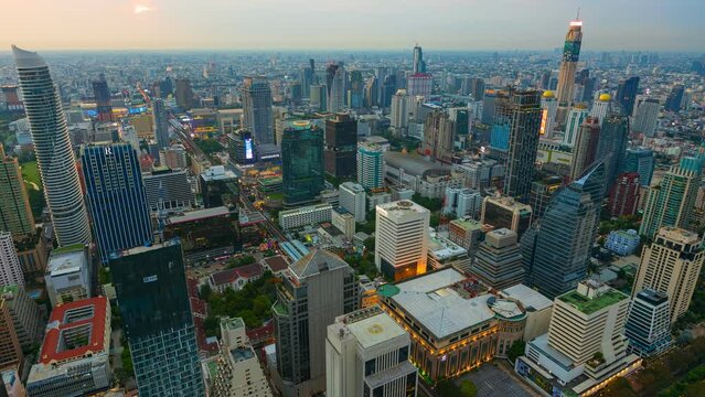 Aerial view of Ploenchit junction with cars traffic skyscraper buildings. Bangkok City in downtown at night, Thailand