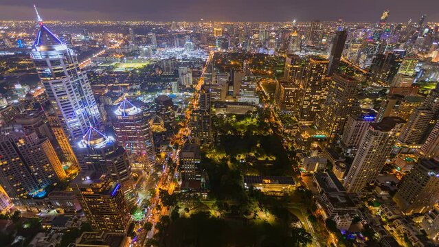 Aerial view of Ploenchit junction with cars traffic skyscraper buildings. Bangkok City in downtown at night, Thailand