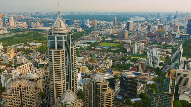 Aerial view of Ploenchit junction with cars traffic skyscraper buildings. Bangkok City in downtown at night, Thailand
