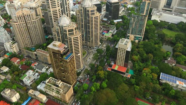 Aerial view of Ploenchit junction with cars traffic skyscraper buildings. Bangkok City in downtown at night, Thailand
