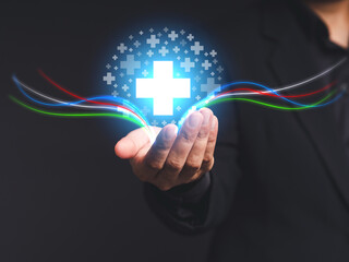 Blue virtual medical icons on the palm businessman in a suit while standing on a gray background