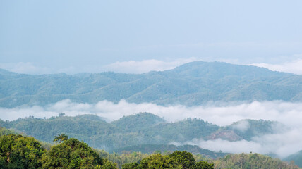 Surreal landscape of morning foggy. Morning clouds at sunrise. Landscape of fog and mountains of northern Thailand